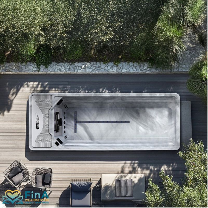 Elegant installation of the Platinum Spas Mini Pool Hades in Sterling Silver - fully recessed in a modern wooden terrace, surrounded by designer furniture and Mediterranean landscaping.